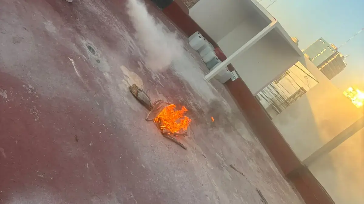 Trainee discharging a fire extinguisher on a small controlled fire during practice