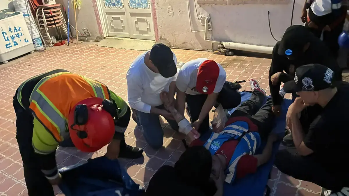 First aid brigade attending to a participant lying on the floor during a training drill