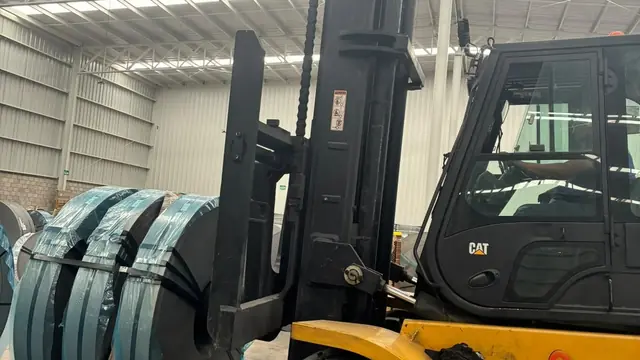 Montacargas de 7 toneladas trasladando una bobina pesada por el piso de una nave industrial